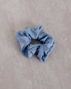 a close up of a light blue colored scrunchie