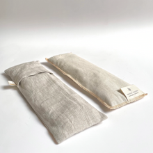 Load image into Gallery viewer, two a natural linen eye pillows, one has the slip cover on it, one does not
