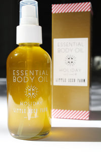 a bottle of holiday body oil by Little Seed Farm