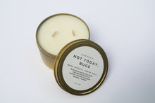 Load image into Gallery viewer, a bug repellent candle with the lid leaning against it
