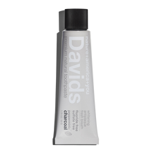 Load image into Gallery viewer, a travel size tube of David&#39;s Natural Toothpaste. it says &quot;Premium Natural Toothpaste. Whitening, Antiplaque, Fresh Breath, Flouride Free, Sulfate Free. Charcoal&quot;
