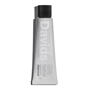a travel size tube of David's Natural Toothpaste. it says "Premium Natural Toothpaste. Whitening, Antiplaque, Fresh Breath, Flouride Free, Sulfate Free. Charcoal"