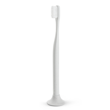 Load image into Gallery viewer, a closeup of the white biodegradable toothbrush mad of cotton
