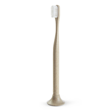 Load image into Gallery viewer, a close up of the tan biodegradable toothbrush made of flax

