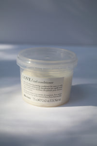 a travel size jar of LOVE curl conditioner by Davines