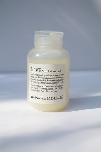 a travel size bottle of LOVE curl shampoo by Davines