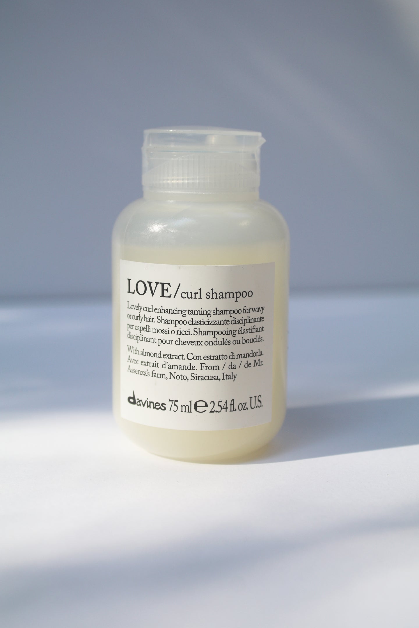 a travel size bottle of LOVE curl shampoo by Davines
