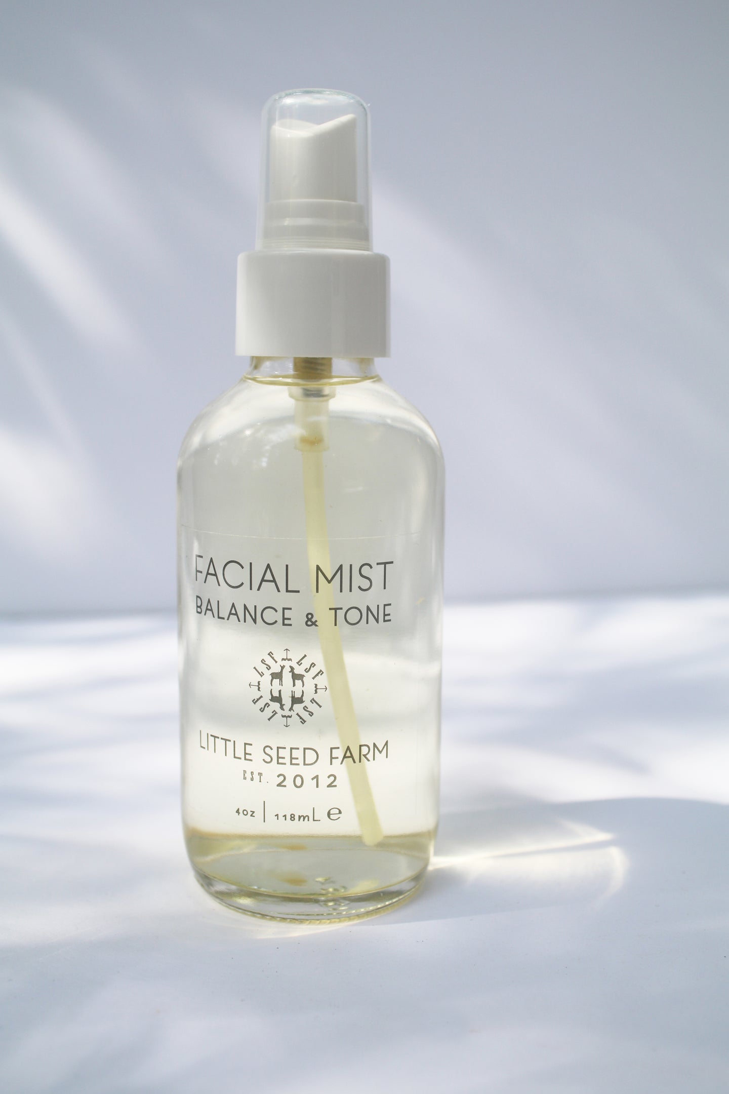 a bottle of facial mist by Little Seed Farm with a spray nozzle
