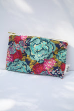 Load image into Gallery viewer, a navy blue colored cosmetic bag with a gold zipper and large floral design
