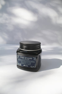a black jar of "Heart of Glass Rich Conditioner" by Davines