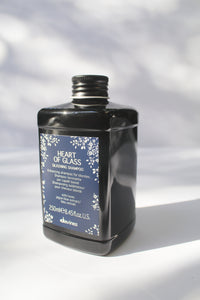 a black jar of "Heart of Glass Silkening Shampoo" by Davines