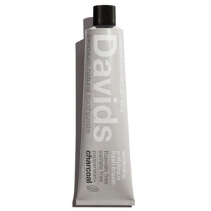 a tube of David's Natural Toothpaste. it says "Premium Natural Toothpaste. Whitening, Antiplaque, Fresh Breath, Flouride Free, Sulfate Free. Charcoal"