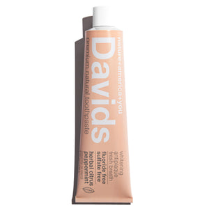 a tube of David's Natural Toothpaste. it says "Premium Natural Toothpaste. Whitening, Antiplaque, Fresh Breath, Flouride Free, Sulfate Free. Herbal Citrus Peppermint essential oil blend"