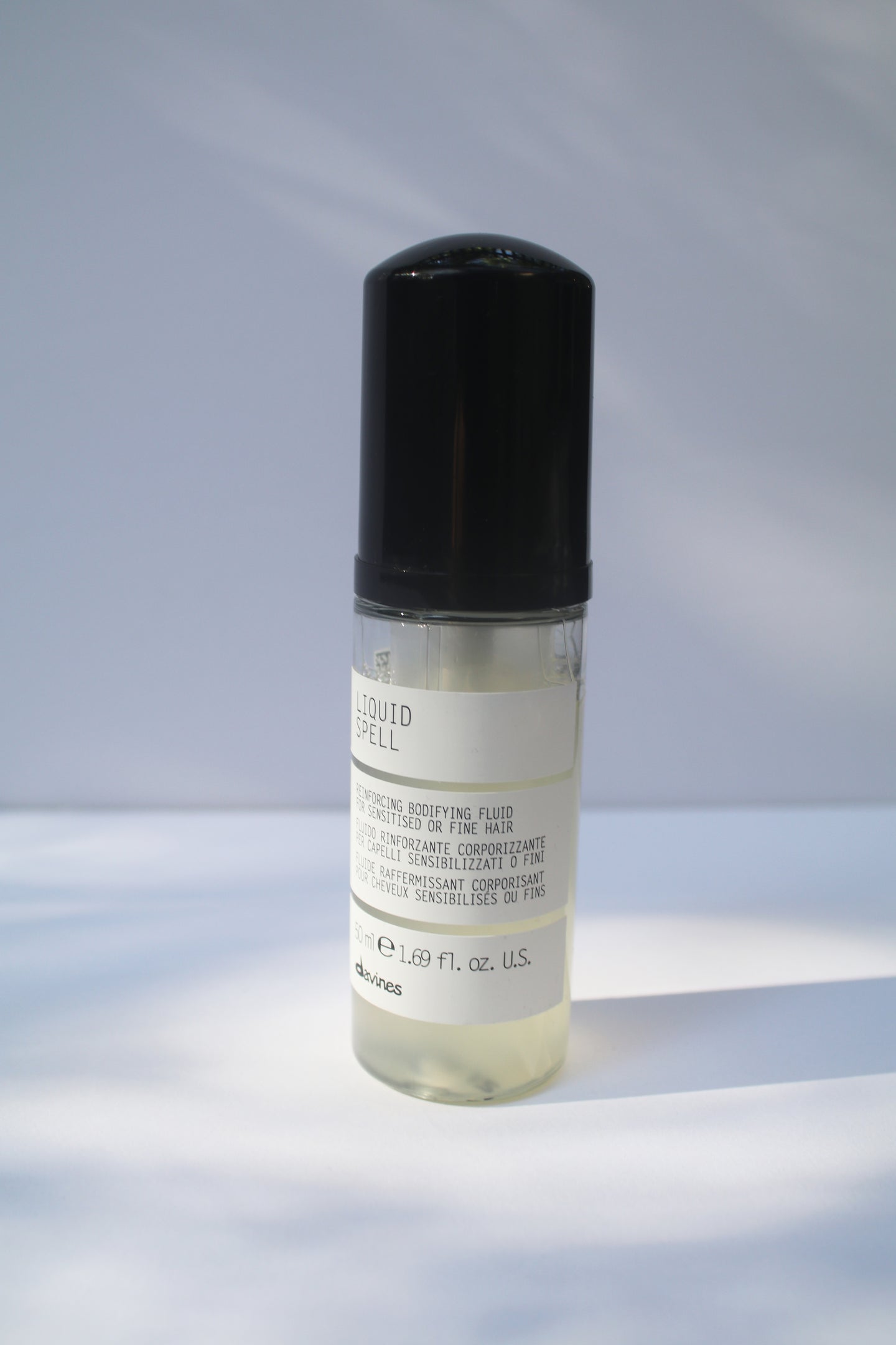 a travel size bottle of liquid spell by Davines with a pump nozzle