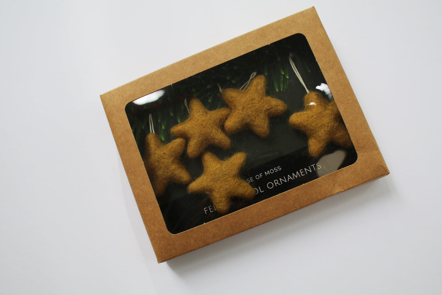 a box of hand felted stars - they  are a maize color