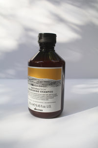 a bottle of "Natural Tech Nourishing Shampoo" by Davines