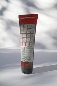 a bottle of "Natural Tech Replumping Conditioner" by Davines
