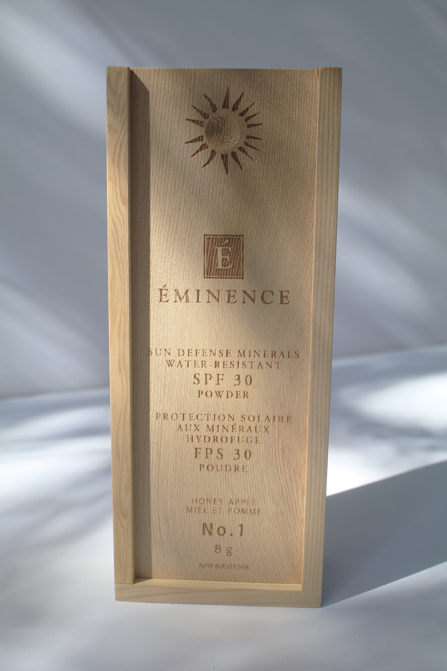 a wooden box containing Sun Defense Mineral Powder, shade Honey Apple, by Eminence