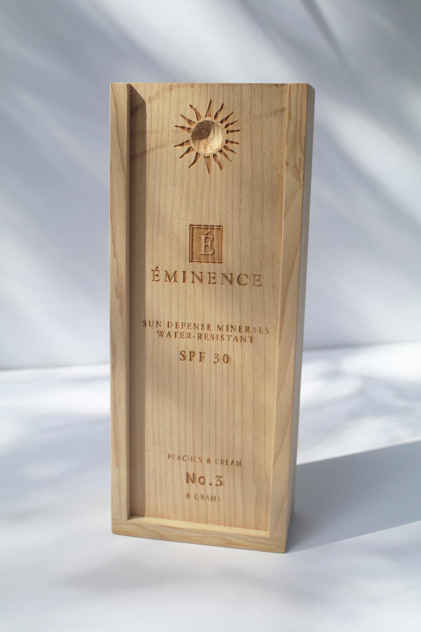 a wooden box containing Sun Defense Mineral Powder, shade Peaches and Cream, by Eminence