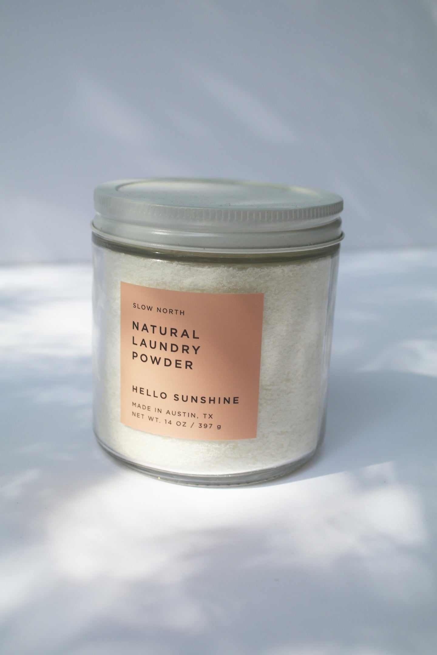 a jar of natural laundry powder, hello sunshine scent